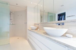 A beautiful modern bathroom with basin sinks and a walk-in shower